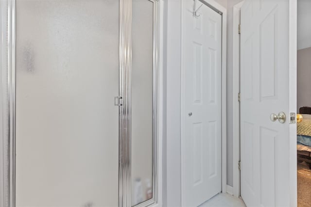 full bathroom with connected bathroom and a shower stall