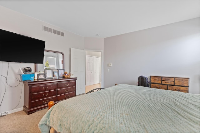 bedroom featuring visible vents and light colored carpet