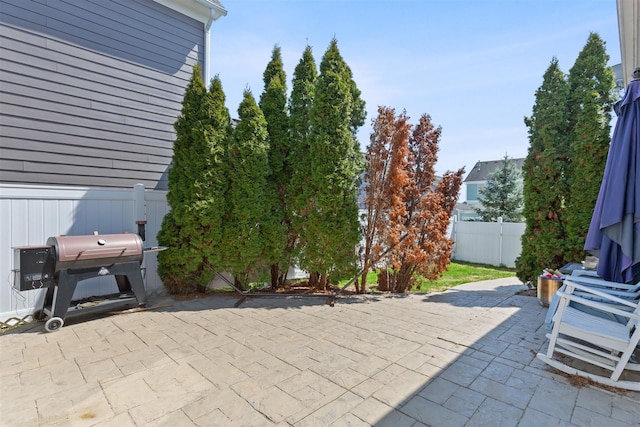 view of patio / terrace featuring grilling area and fence