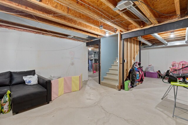 unfinished basement featuring stairs