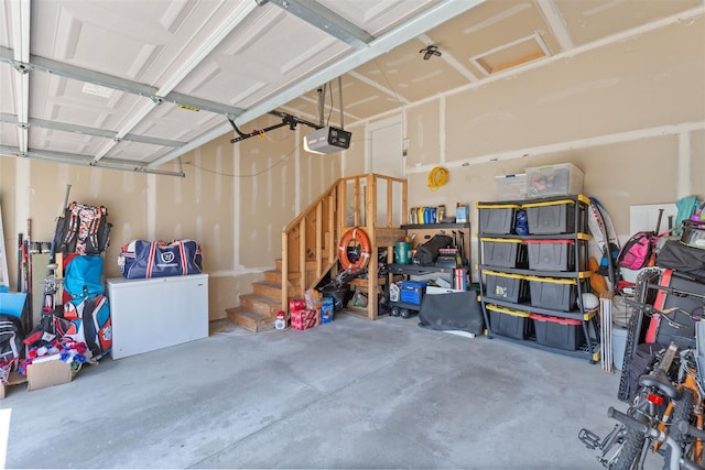 garage featuring a garage door opener and fridge