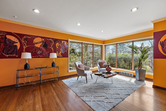 living area featuring baseboards, crown molding, visible vents, and plenty of natural light