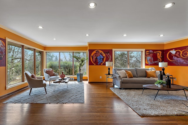 living room with hardwood / wood-style flooring, baseboards, recessed lighting, and crown molding