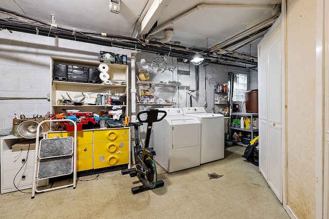 unfinished basement with washing machine and clothes dryer and tile patterned floors