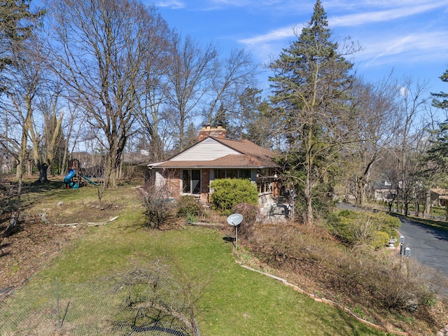 exterior space featuring a chimney and a playground