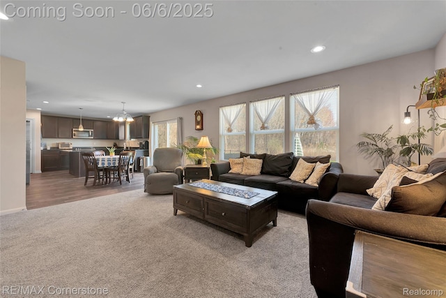 51306 Kirby Dr, Chesterfield, MI 48047 - living area with light carpet, recessed lighting, and a chandelier