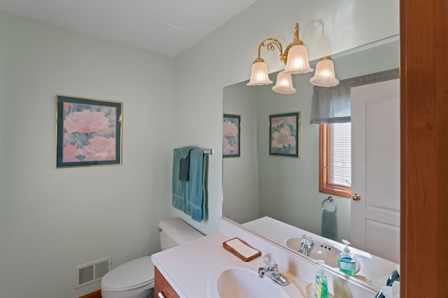 bathroom with visible vents, toilet, and vanity