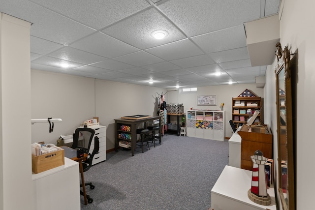 carpeted office space with baseboards and a paneled ceiling