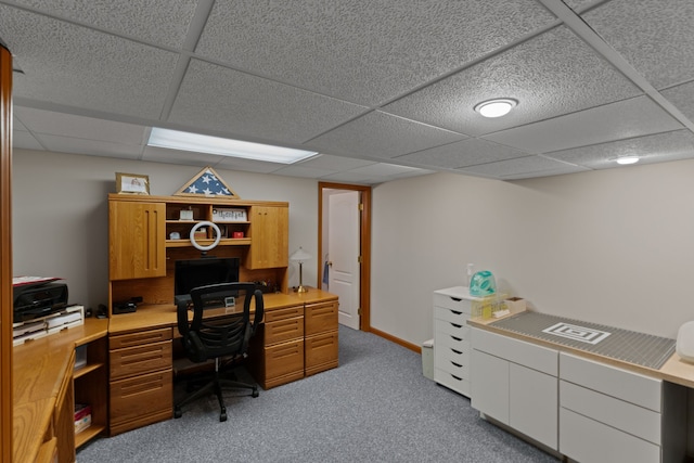 home office with carpet flooring and a paneled ceiling