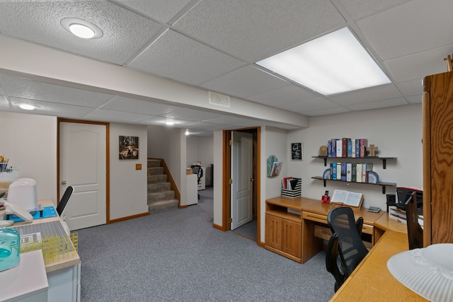 office area with a drop ceiling, carpet flooring, and visible vents
