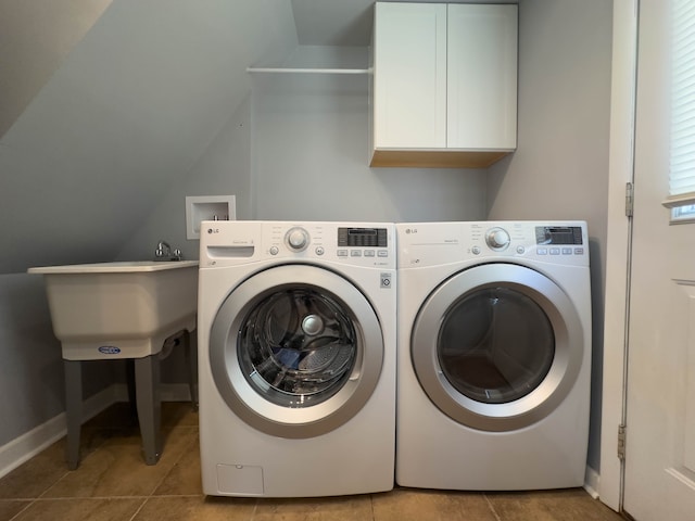 laundry area featuring cabinet space, washing machine and clothes dryer, tile patterned flooring, and baseboards