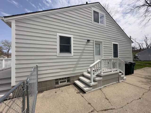 rear view of property featuring fence