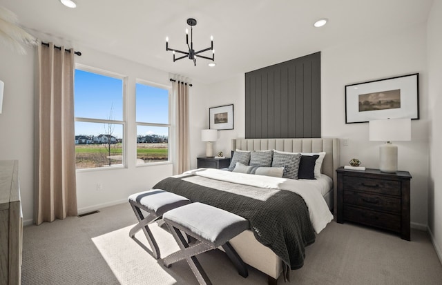 carpeted bedroom with recessed lighting, visible vents, baseboards, and an inviting chandelier