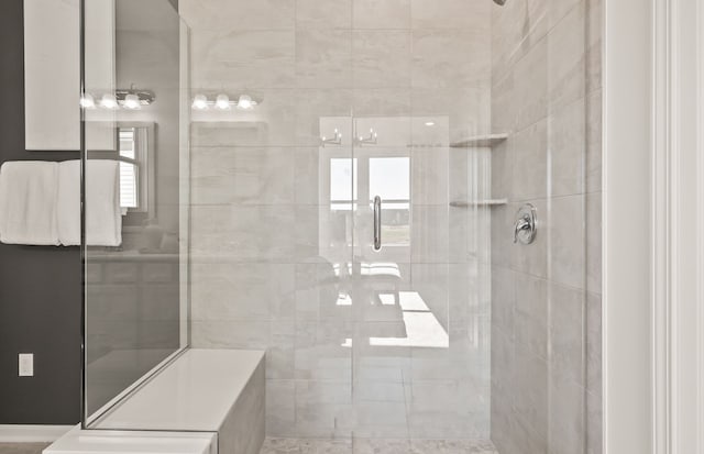 full bathroom featuring a shower stall and a wealth of natural light