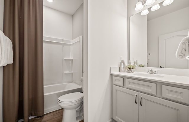 full bathroom with toilet, vanity, wood finished floors, and shower / bathing tub combination