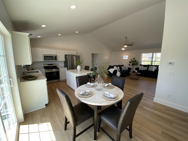 9150 Cottage Xing Unit 23, Richland, MI 49083 - dining area featuring ceiling fan, vaulted ceiling, light wood-style floors, baseboards, and recessed lighting