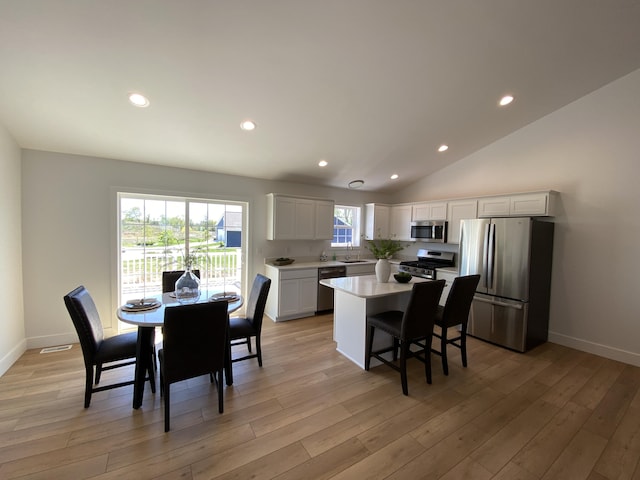 9150 Cottage Xing Unit 23, Richland, MI 49083 - dining area featuring light wood-style flooring, recessed lighting, baseboards, and vaulted ceiling