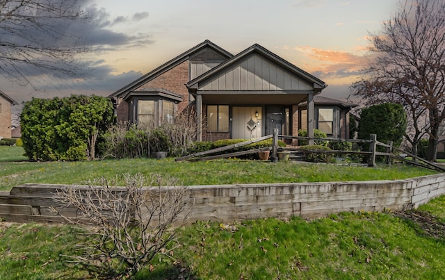 bungalow-style home with a front lawn and brick siding