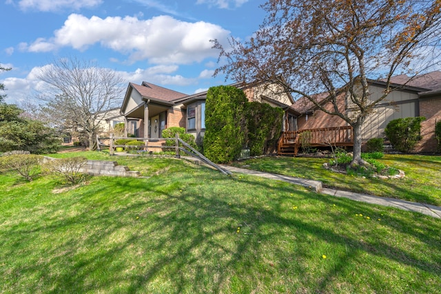view of front of home featuring a wooden deck and a front yard