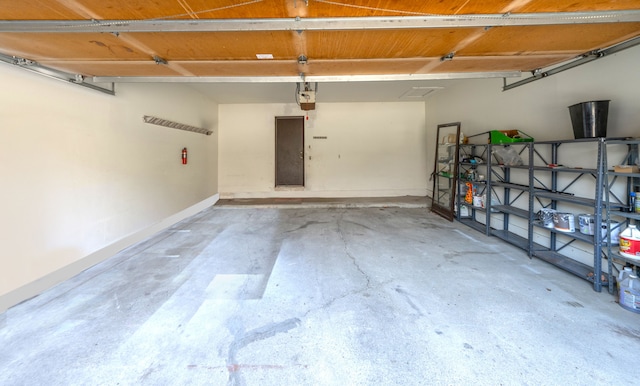 garage featuring baseboards and a garage door opener