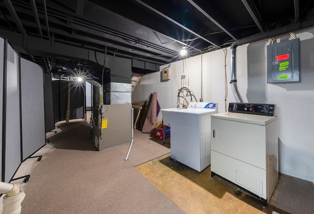 unfinished below grade area featuring heating unit, a sink, separate washer and dryer, electric panel, and carpet