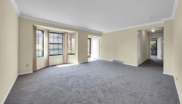 empty room featuring visible vents, carpet, and ornamental molding