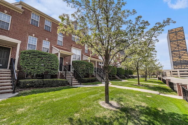 view of property's community featuring a yard and stairs