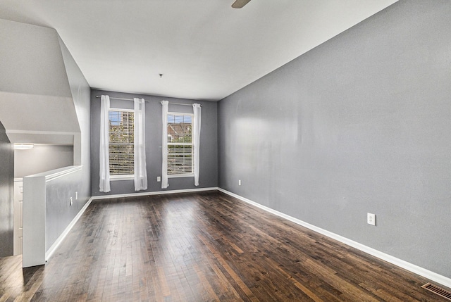 unfurnished living room with baseboards, ceiling fan, visible vents, and wood finished floors