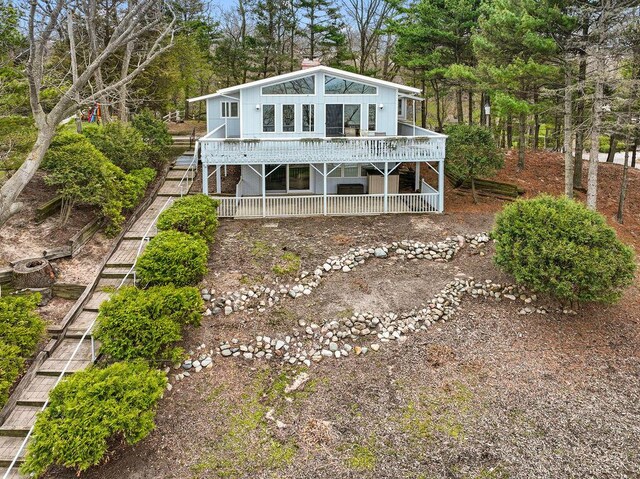 back of property featuring a wooden deck and stairs