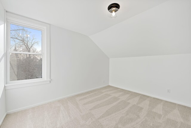 516 W Detroit St, New Buffalo, MI 49117 - bonus room featuring vaulted ceiling, carpet flooring, and baseboards