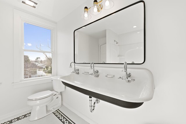 516 W Detroit St, New Buffalo, MI 49117 - bathroom featuring a sink, toilet, visible vents, baseboards, and tile patterned flooring
