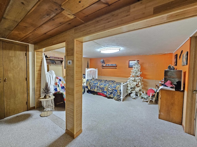 carpeted bedroom with wooden walls