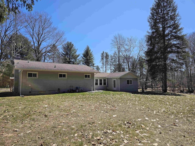 back of property with a yard