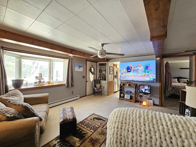 carpeted living area with a baseboard radiator and ceiling fan