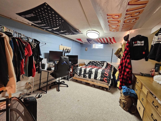 bedroom featuring concrete block wall and carpet