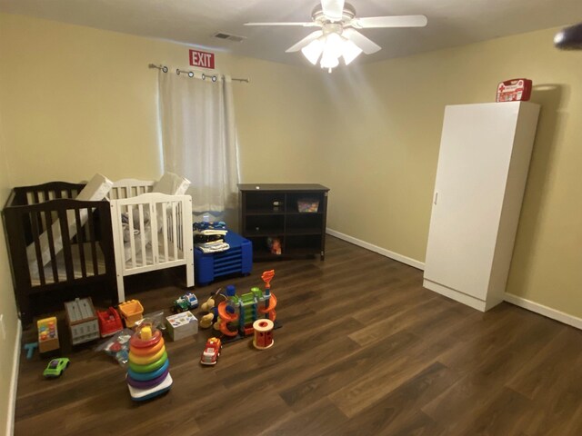 835 Eden St, Kingsley, MI 49649 - bedroom featuring a nursery area, baseboards, wood finished floors, and visible vents