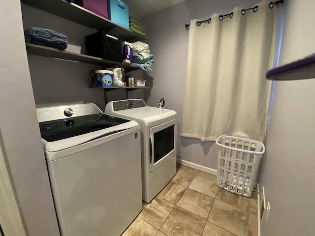 835 Eden St, Kingsley, MI 49649 - clothes washing area featuring washing machine and clothes dryer, baseboards, and laundry area