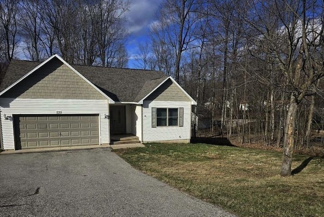 835 Eden St, Kingsley, MI 49649 - ranch-style home with aphalt driveway, a front yard, and a garage