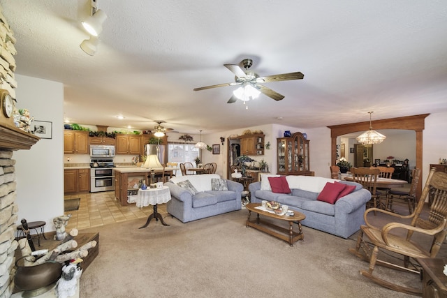 9155 Ivanhoe Dr, Onekama, MI 49675 - living area with light carpet and ceiling fan with notable chandelier