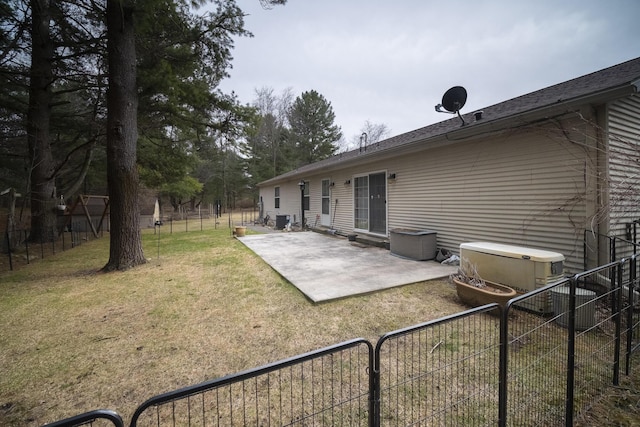 9155 Ivanhoe Dr, Onekama, MI 49675 - rear view of house featuring a fenced backyard, a yard, and a patio
