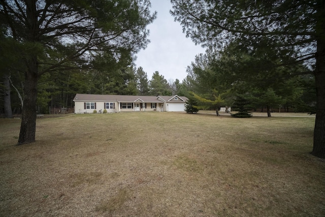 9155 Ivanhoe Dr, Onekama, MI 49675 - view of front of property featuring an attached garage and a front yard