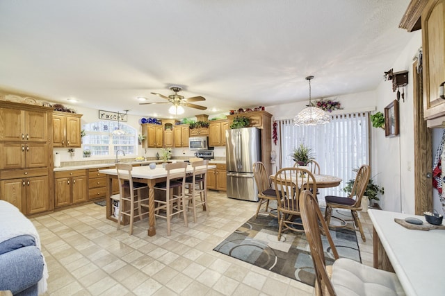 9155 Ivanhoe Dr, Onekama, MI 49675 - dining space with ceiling fan with notable chandelier and recessed lighting