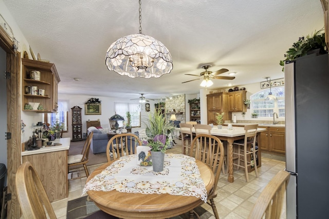 9155 Ivanhoe Dr, Onekama, MI 49675 - dining area with ceiling fan with notable chandelier