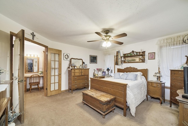 9155 Ivanhoe Dr, Onekama, MI 49675 - bedroom with a textured ceiling, a ceiling fan, light colored carpet, and french doors