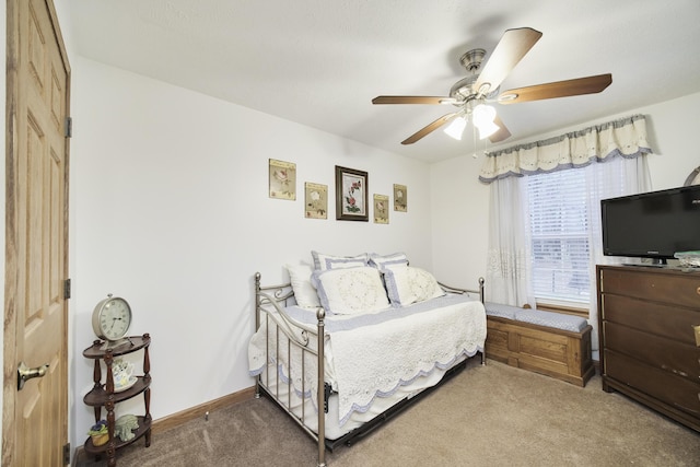 9155 Ivanhoe Dr, Onekama, MI 49675 - carpeted bedroom with baseboards and ceiling fan