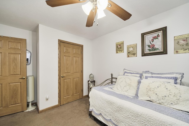 9155 Ivanhoe Dr, Onekama, MI 49675 - bedroom featuring light carpet, a ceiling fan, and baseboards