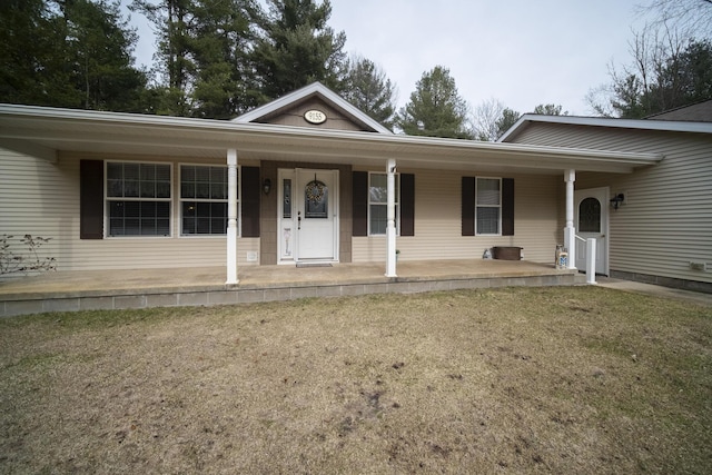 9155 Ivanhoe Dr, Onekama, MI 49675 - view of front of house featuring covered porch