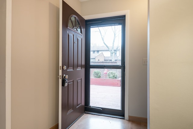 interior space with baseboards and a healthy amount of sunlight