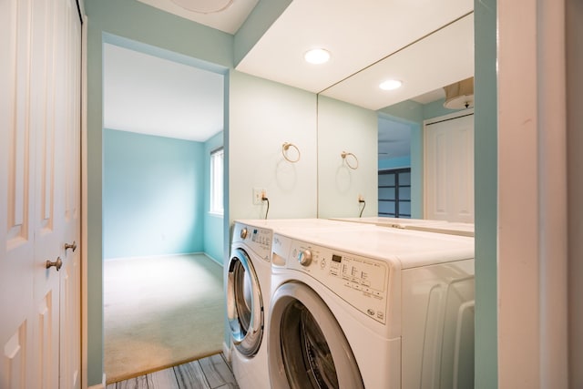 laundry area featuring washing machine and dryer, carpet floors, laundry area, and baseboards