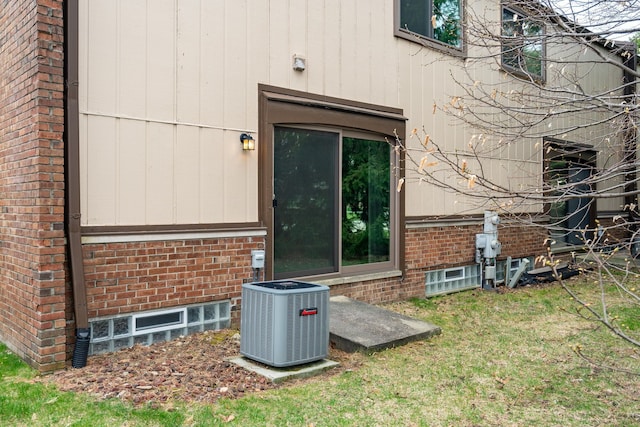 exterior space featuring brick siding and central air condition unit